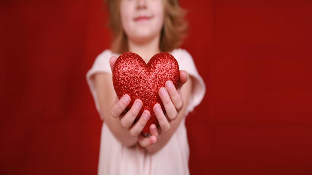 Dakota Medical Foundation girl with glittery heart image